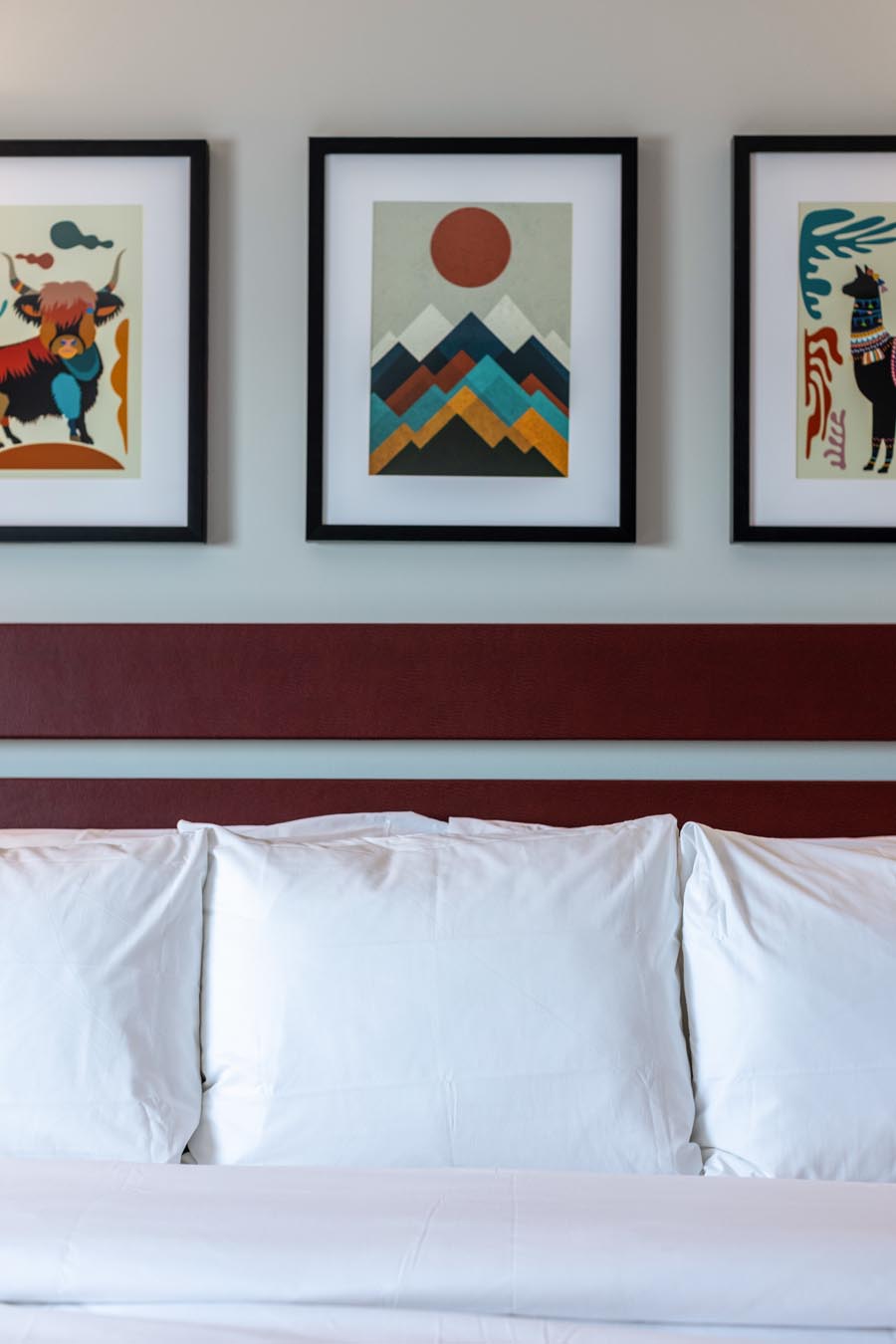 Bed with pictures hanging above it