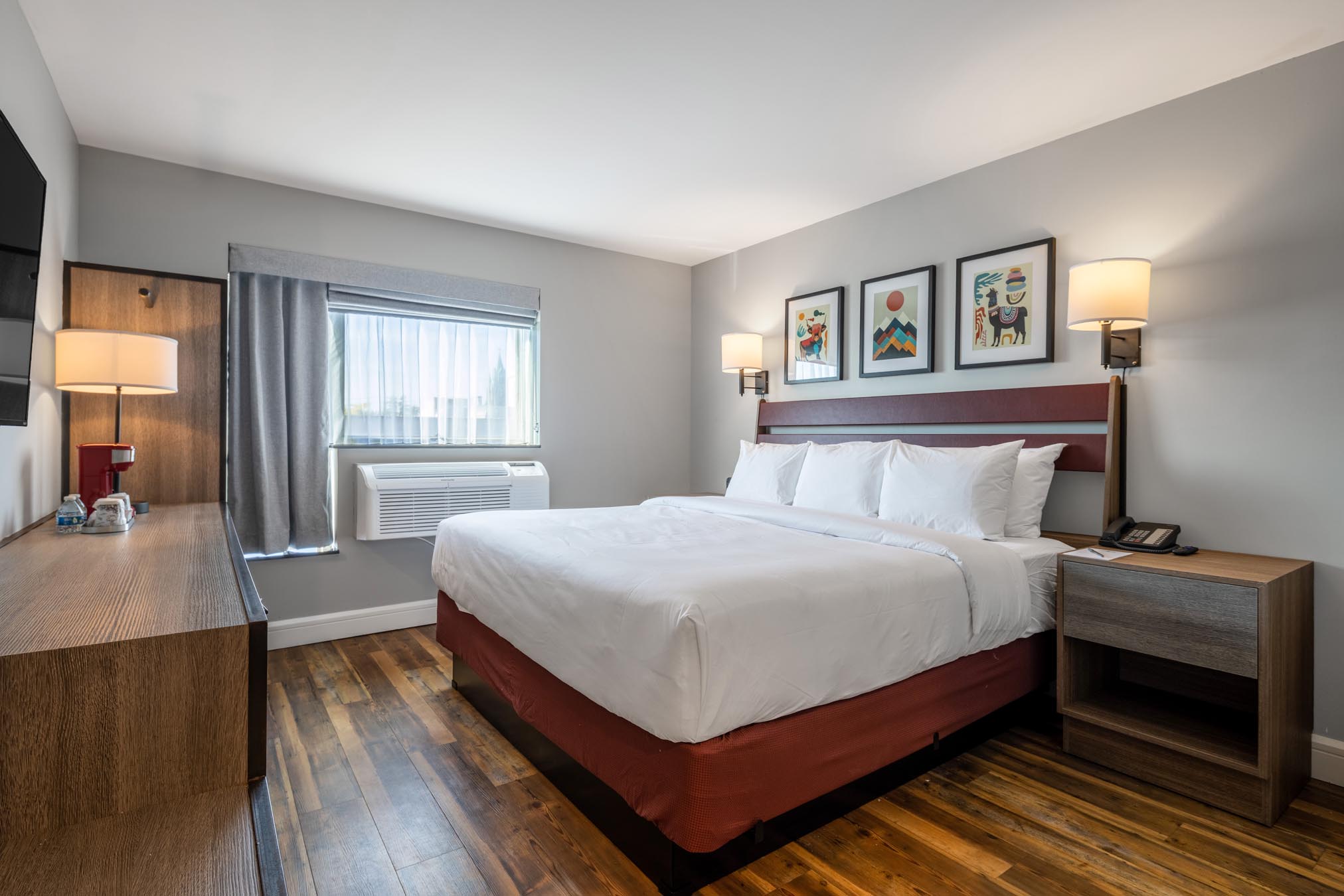 King bed in room with hardwood floors