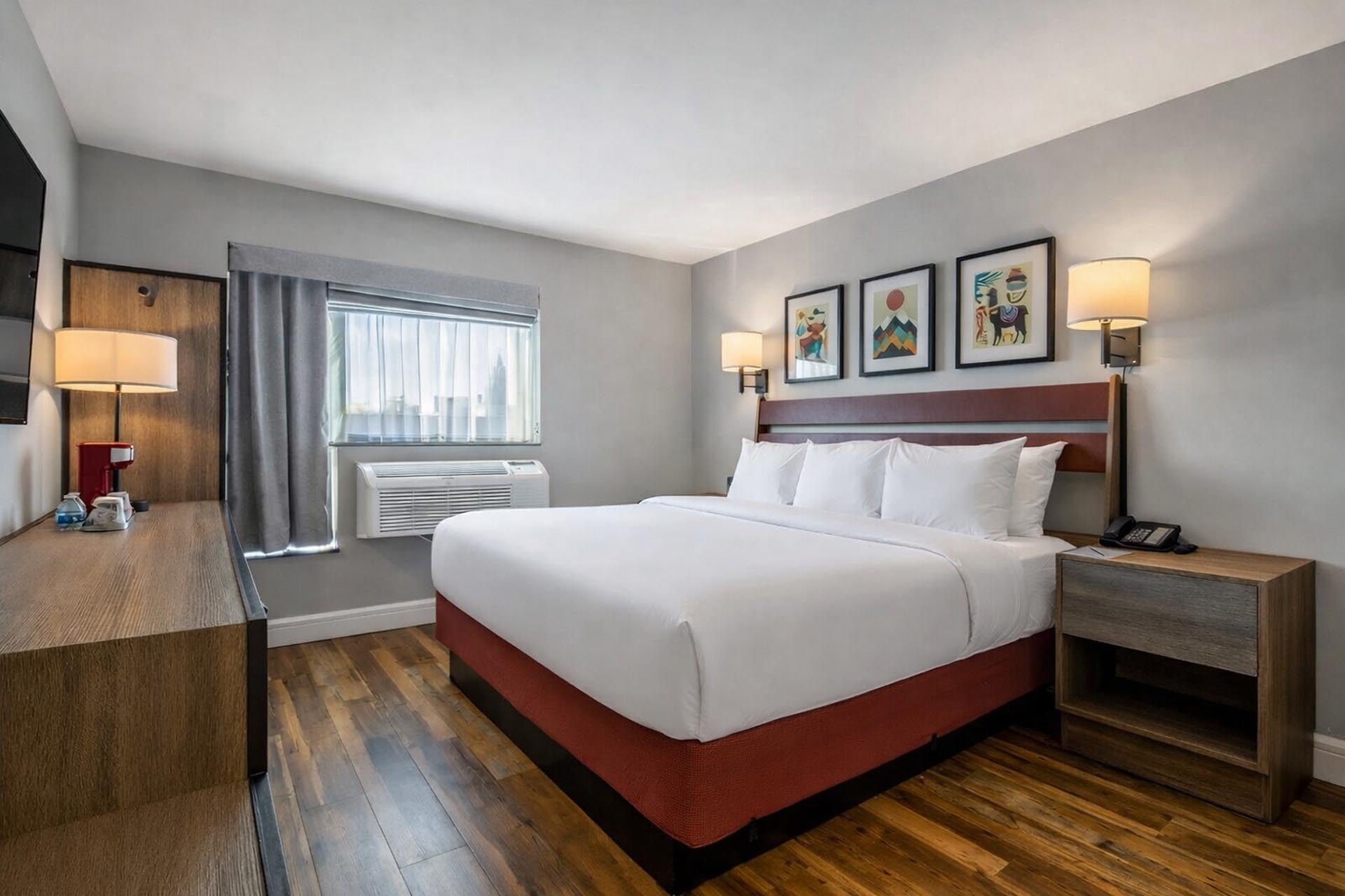 King bed in room with hardwood floors